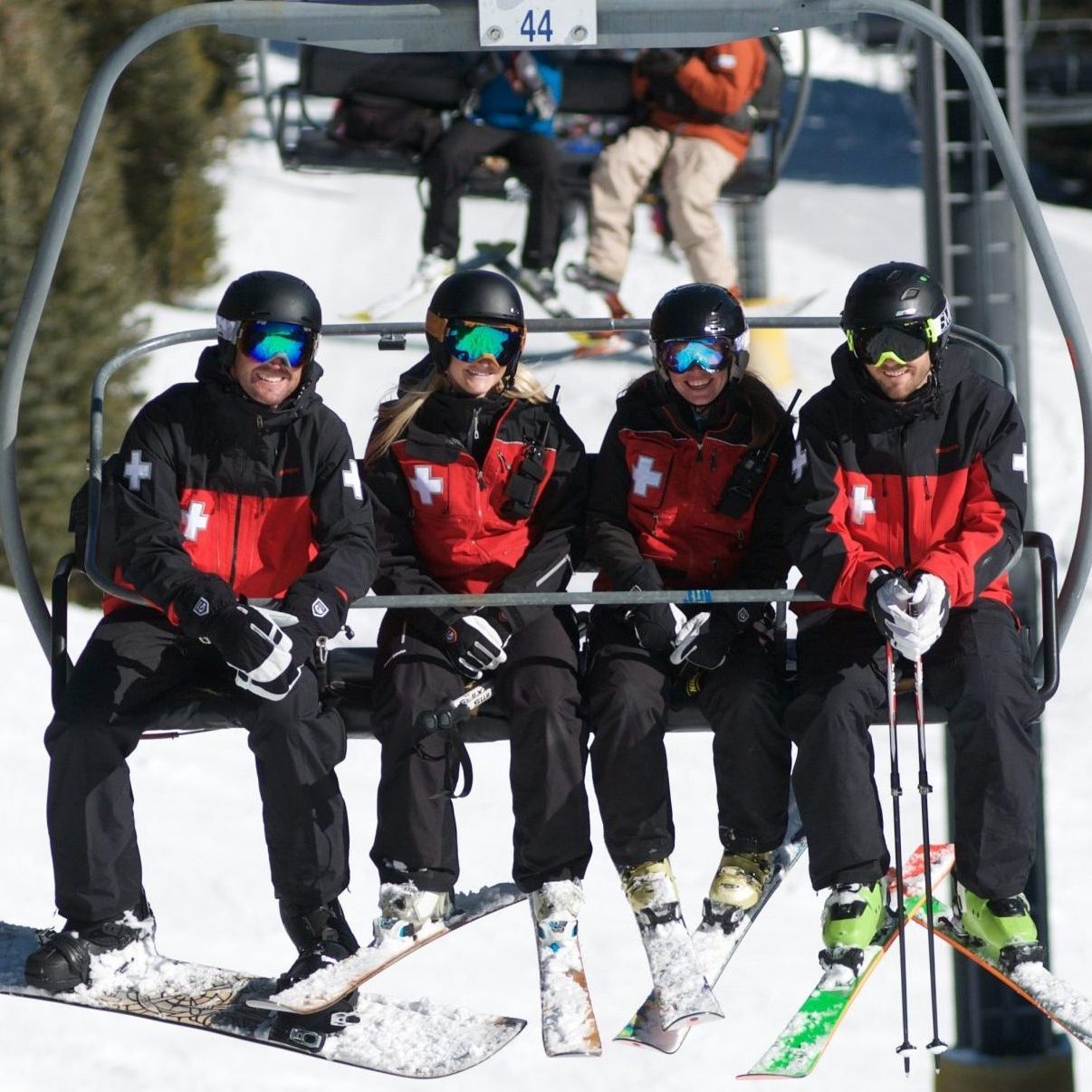 patrollers on ski lift chair