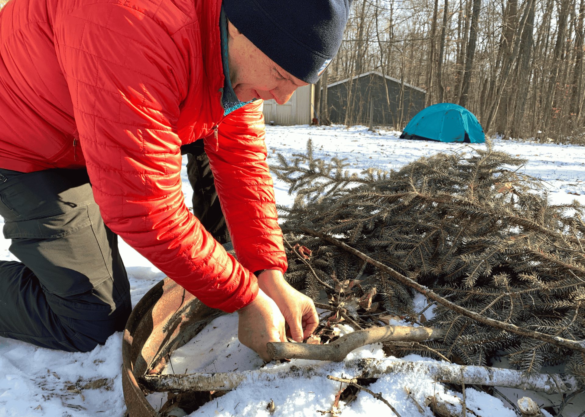 man starting a fire in the winter with flint