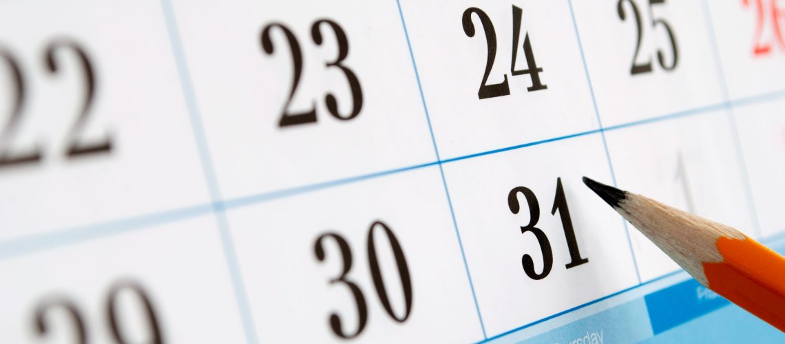 home calendar with dates and yellow sharpened pencil